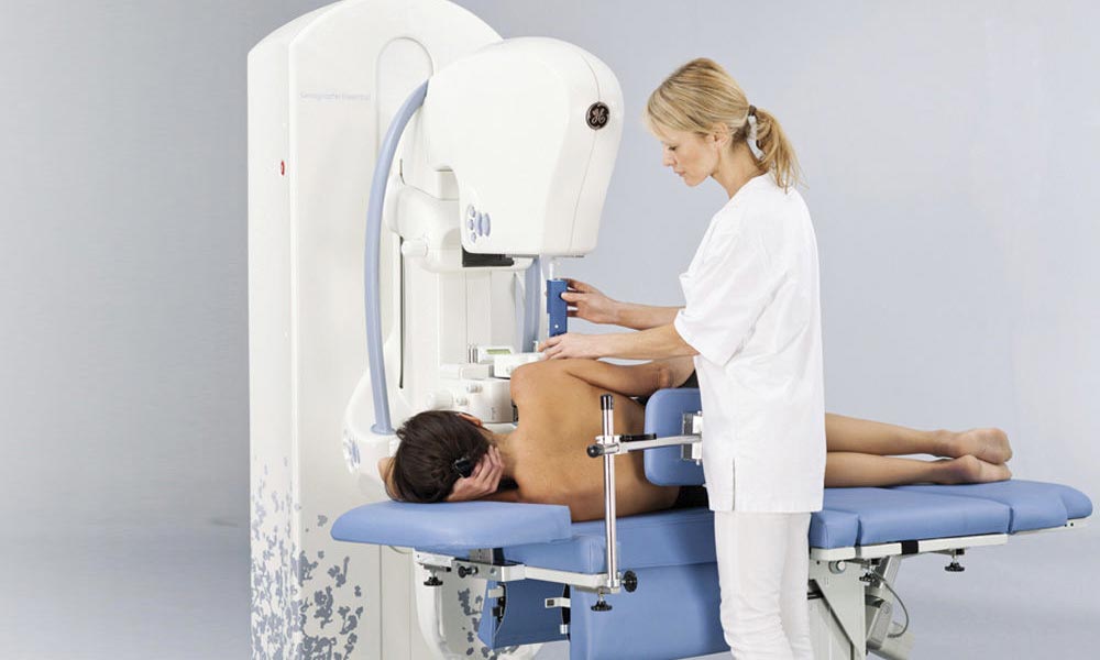 patient receiving a stereotactic biopsy during mammogram with technician