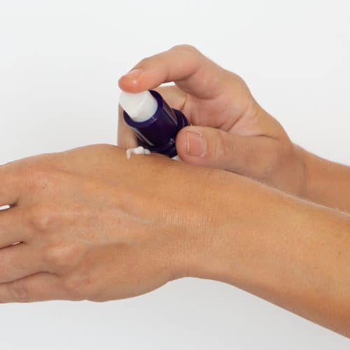woman dispensing sientra biocorneum scar cream on hand