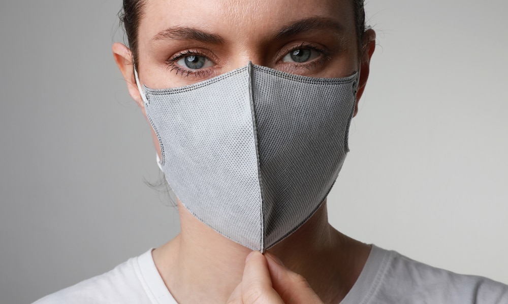 woman with gray mask thinking about covid