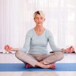 older woman in meditation pose