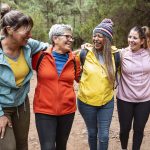 group of women hiking and laughing